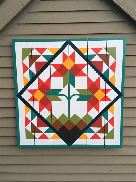 barn quilts for a tan and green metal house|barn quilts for christmas.